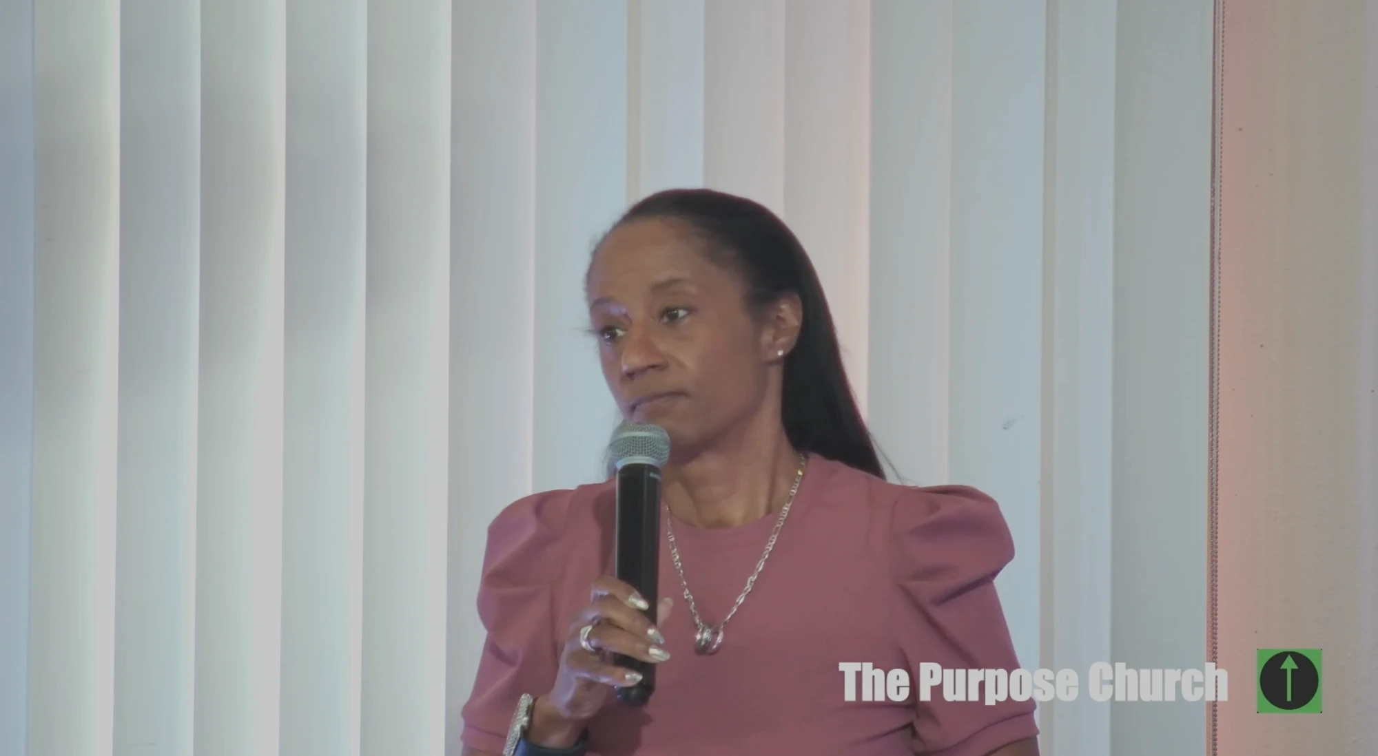 A woman sharing during Sunday worship at The Purpose Church in Kent, WA